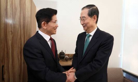 국민의힘 김문수 대선후보(왼쪽)와 무소속 한덕수 대선 예비후보가 7일 서울 종로구의 한 식당에서 후보 단일화 관련 회동을 하기 전 악수하고 있다. 공동취재사진