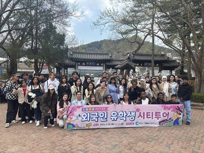 ▲남이섬 앞에서 외국인 유학생 시티투어 참여 학생들이 단체사진을 찍고 있다./사진제공=춘천시
