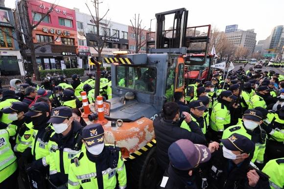 트랙터 둘러싼 경찰 - 지난 3월 서울 종로구 자하문로에서 경찰들이 전국농민회총연맹(전농) 소속 트랙터를 둘러싸고 있는 가운데 시민단체 회원들과 대치하고 있다.  연합뉴스