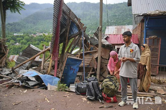 [우리=AP/뉴시스] 지난 9일(현지 시간) 인도령 카슈미르 우리 지역 긴갈 마을에서 한 가족이 밤사이 파키스탄의 포격을 받은 마을을 떠나며 대중교통을 기다리고 있다. 2025.05.10.