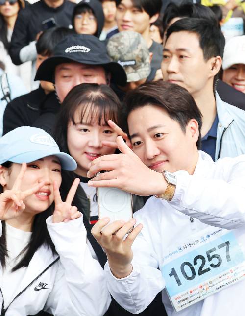 이준석 개혁신당 대선 후보가 11일 오전 부산 해운대구 벡스코 인근에서 열린 다이아몬드브리지 걷기 축제에 참가해 시민들과 사진을 찍고 있다. 연합뉴스