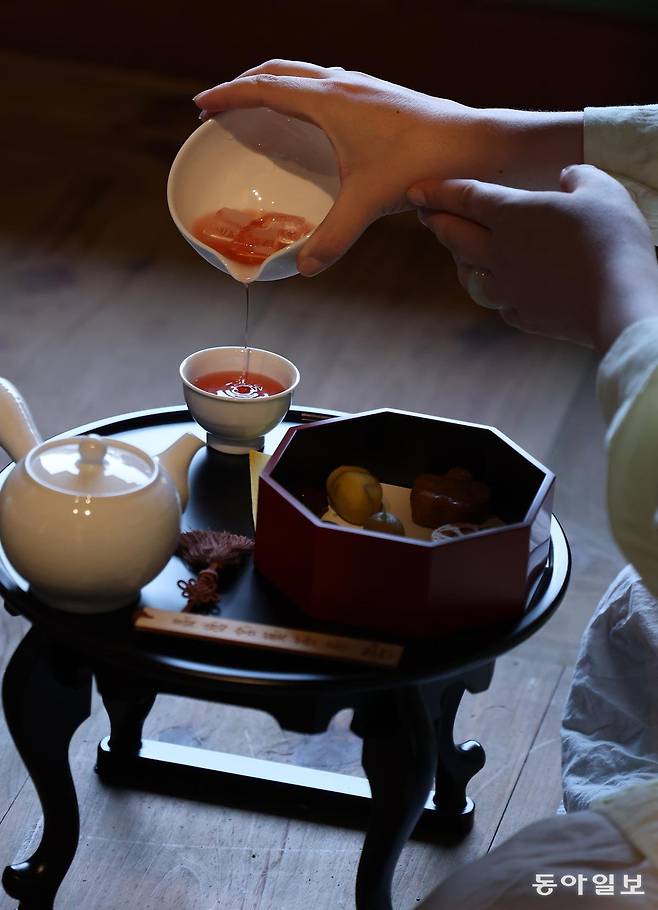 12일 서울 종로구 창덕궁 약방에서 열린 2025년 창덕궁 약다방 사전 행사에서 한 외국인이 전통다과를 스마트폰 카메라로 촬영하고 있다. 송은석 기자 silverstone@donga.com