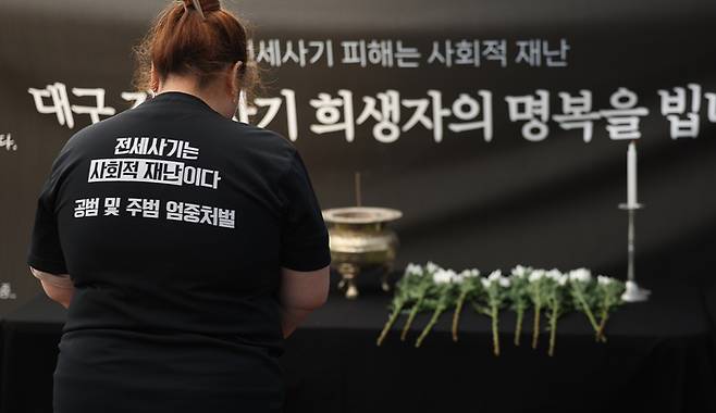 지난 5월 2일 대구 중구 동성로에 설치된 대구 전세사기 희생자 1주기 추모 분향소에서 한 시민이 희생자를 추모하며 묵념하고 있다. [사진 = 연합뉴스]