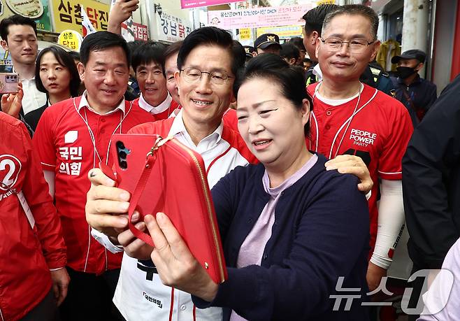 김문수 국민의힘 대통령 후보가 13일 울산 중구 청년야시장에서 유세 도중 상인들과 사진을 찍고 있다. 2025.5.13/뉴스1 ⓒ News1 김민지 기자