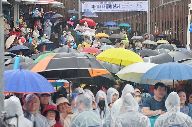 15일 오후 전남 여수시 이순신 광장에서 우산과 우비를 쓴 시민들이  대통령 후보의 연설을 지켜보고 있다. (공동취재) 2025.5.15/뉴스1 ⓒ News1 안은나 기자