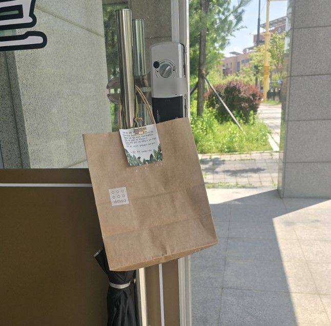 [서울=뉴시스] 학생이 빌려줬던 우산과 함께 손 편지와 간식이 담긴 봉투를 전했다.(사진=아프니까 사장이다 갈무리) *재판매 및 DB 금지