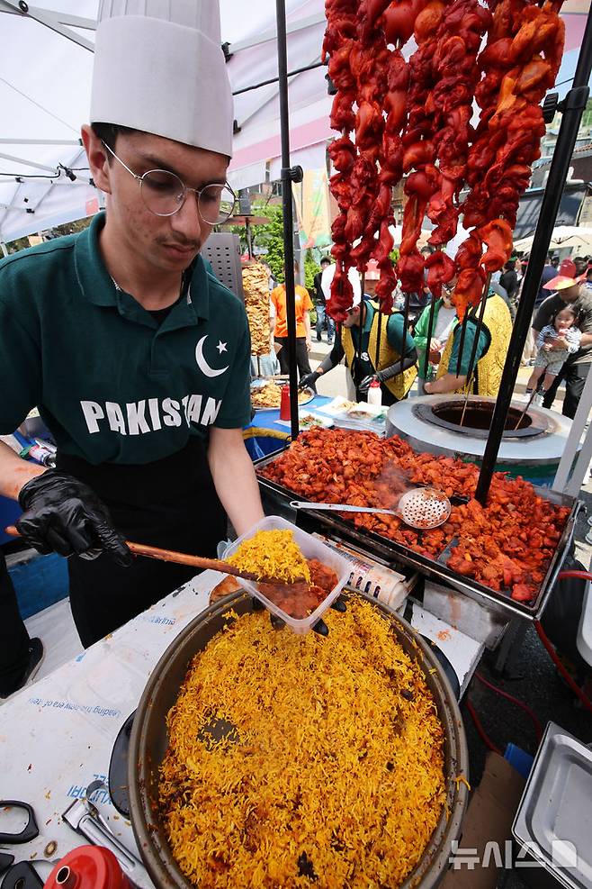 [서울=뉴시스] 김금보 기자 = 18일 서울 성북구 성북동 주민센터 건너편 성북로 일대에서 열린 '제 17회 성북세계음식축제 누리마실'에서 각국 요리사들이 대표음식을 만들고 있다. 2025.05.18. kgb@newsis.com