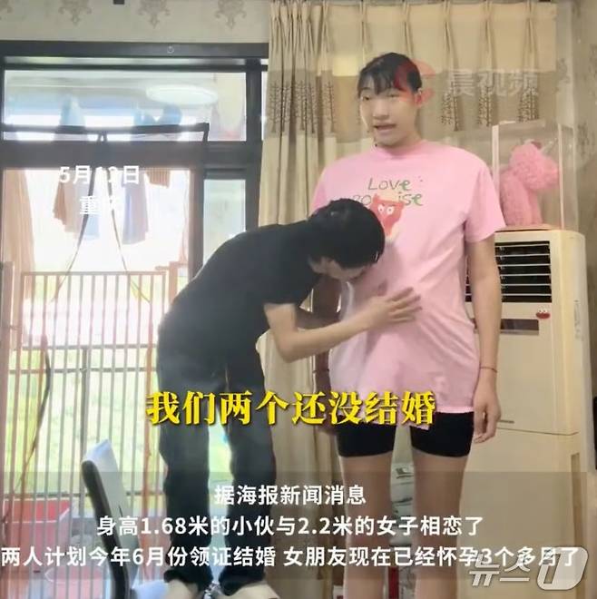 남성이 의자에 올라가 임신한 여성의 배를 만지고 있다. - 웨이보 갈무리