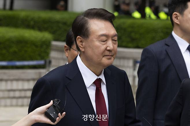 윤석열 전 대통령이 19일 서울 서초구 서울중앙지법에서 열린 내란 우두머리 혐의, 직권남용 권리행사방해 혐의 사건 4차 공판의 오전 재판 종료 후 점심 식사를 위해 나서며 취재진의 질문을 받고 있다. 사진공동취재단