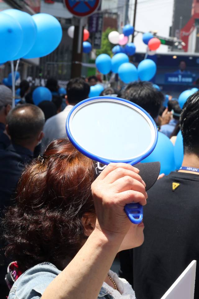 이재명 더불어민주당 대선 후보가 14일 부산 부산진구 서면거리에서 유권자들에게 지지를 호소하고 있는 가운데 지지자들이 파란풍선과 거울을 들고 있다. 부산=오승현 기자 2025.05.14