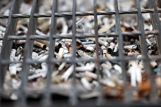 Cigarette butts pile up in a gutter near Gangnam Station in southern Seoul on June 23, 2023. [YONHAP]