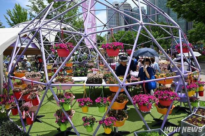 서울국제정원박람회가 열리는 서울 동작구 보라매공원에서 22일 오전 시민들이 꽃 판매부스를 살펴보고 있다. 2025 서울국제정원박람회는 10월 20일까지 열린다.&nbsp;