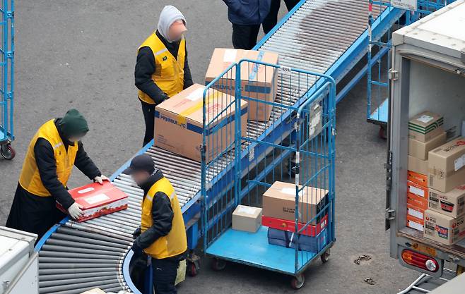 서울의 한 택배 물류센터에서 택배 기사들이 분주히 배송 준비 작업을 하고 있다./뉴스1