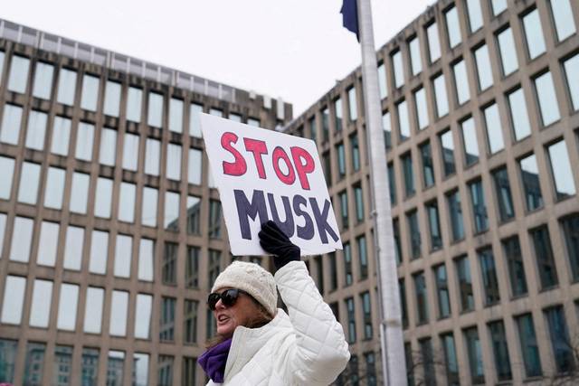 지난 2월 2일(현지시간) 미국 워싱턴DC 인사관리처 청사 앞에서 한 여성이 일론 머스크 정부효율부(DOGE) 수장의 연방정부 구조조정에 반대하는 팻말을 들고 있다. 로이터연합뉴스