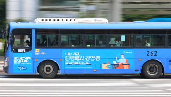 서울시 시내버스 노조가 28일 총파업을 선언한 가운데 26일 서울 영등포구 여의도버스환승센터에서 승객을 태운 버스가 도로 위를 지나고 있다. [연합뉴스]