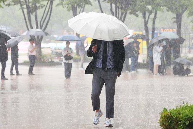 전국 대부분 지역에 비 또는 소나기가 내린 16일 서울 광장에서 우산을 쓴 시민들이 발걸음을 재촉하고 있다. 연합뉴스