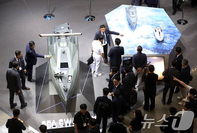 28일 부산 해운대구 벡스코 제1전시장에서 열린 '2025 국제해양방위산업전(MADEX)'에서 참가자들이 LIG넥스원 부스를 찾아 미래 무인수상정 콘셉트 모델 '해검-X'를 살펴보고 있다.  2025.5.28/뉴스1 ⓒ News1 윤일지 기자