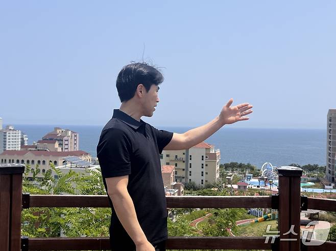 울산 북구 산하동 강동블루마시티발전협의회 사무장이 강동 중앙공원에 올라 정자항 해상에 추진되는 고정식 해상풍력 단지 조성과 관련 조망을 설명하고 있다.2025.5.25./뉴스1 김세은 기자