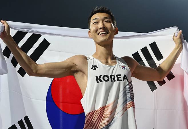 우상혁(용인시청)이 29일 경북 구미시민운동장에서 열린 ‘2025 구미 아시아육상선수권대회’ 높이뛰기 결승에서 2m29 기록으로 우승 확정 후 태극기를 두르고 기뻐하고 있다. 2025.5.29/뉴스1