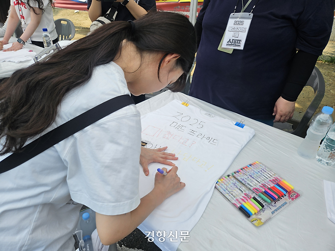 ‘2025 매드프라이드 서울’에 참여한 임주은씨(24)가 행사 부스에서 면 티셔츠를 꾸미고 있다. 박채연 기자