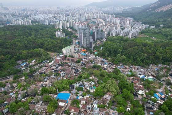 An aerial view shows Baeksa Village in Nowon District, northern Seoul, undergoing demolition on May 15, with surrounding apartment complexes in the background. [YONHAP]