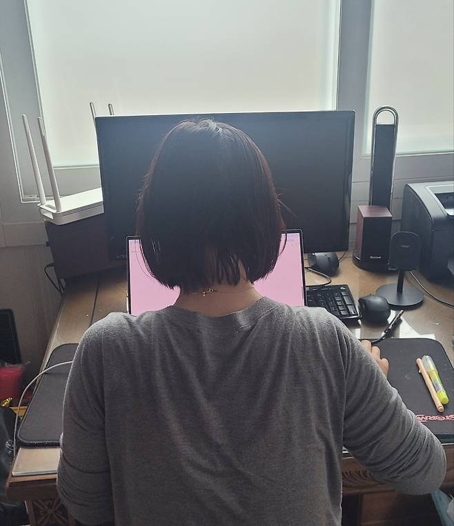 Career counselor Lee, 44, uses her laptop to look up information about the upcoming June 3 election at her home in Daegu. (Lee)