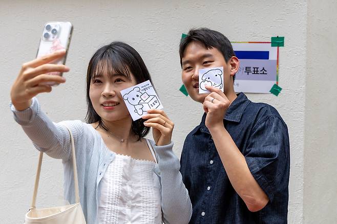 울산 남구 삼산초등학교에 마련된 '삼산동 제7·9투표소'에서 유권자들이 투표를 마친 뒤 인증샷을 남기고 있다. 최지원 기자
