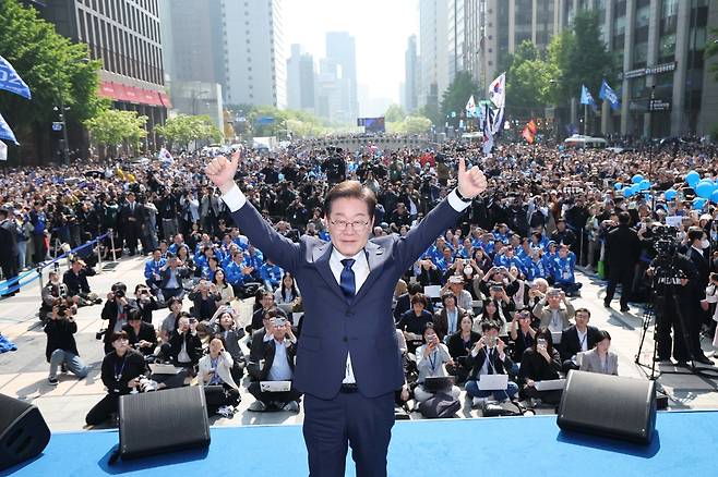 더불어민주당 이재명 대선 후보가 6·3 대통령선거 공식 선거운동 첫날인 12일 ‘빛의 혁명’을 상징하는 공간인 서울 광화문 청계광장에서 첫 유세를 시작하며 두 팔을 번쩍 들고 있다.  이상섭 기자