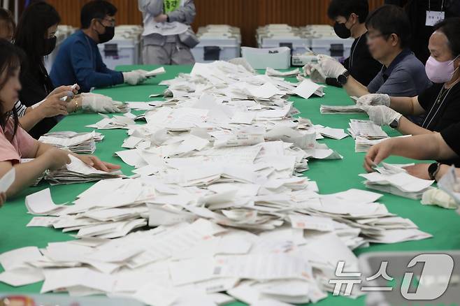제21대 대통령 선거 투표가 종료된 3일 오후 부산 남구 국립부경대학교 대연캠퍼스 체육관에 마련된 개표소에서 개표사무원들이 투표지 분류 작업을 하고 있다. 2025.6.3/뉴스1 ⓒ News1 윤일지 기자