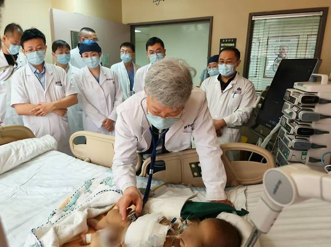 서울아산병원 간이식·간담도외과 이승규 석좌교수가 중국 칭화대 부속 창궁병원에서 생체 간이식 수술을 받은 환아의 상태를 살펴보고 있다./사진=서울아산병원