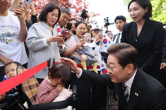 이재명 대통령과 김혜경 여사가 4일 인천 계양구 사저를 출발하며 한 어린이와 인사하고 있다. [연합]