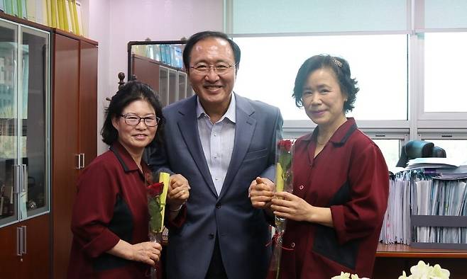 노회찬 정의당 의원이 여성의날 국회 청소 노동자들에게 장미를 선사하고 기념촬영을 하고 있다. 한겨레 자료사진