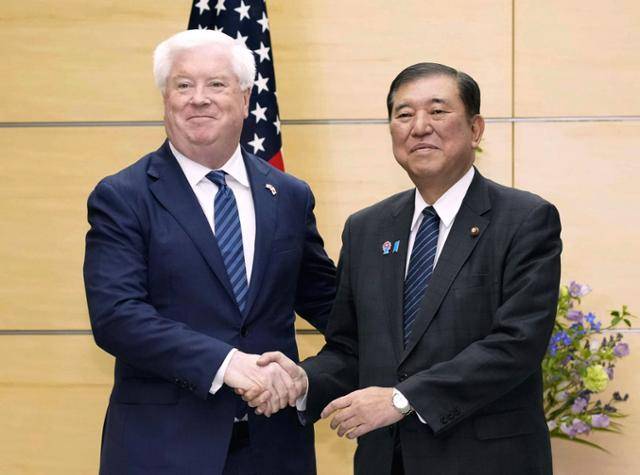 이시바 시게루(오른쪽) 일본 총리가 4월 22일도쿄 총리 관저에서 조지 글래스 주일 미국대사와 악수하고 있다. 도쿄=AP 뉴시스