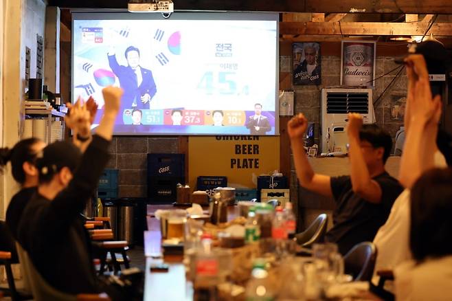 제21대 대통령선거가 치러진 3일 광주 동구 대의동 한 호프집에서 시민들이 개표방송을 보며 환호하고 있다.  사진=연합뉴스