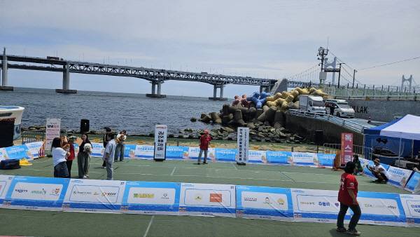 반려견 달리기 대회장 뒤편으로 부산의 랜드마크인 광안대교가 보인다.