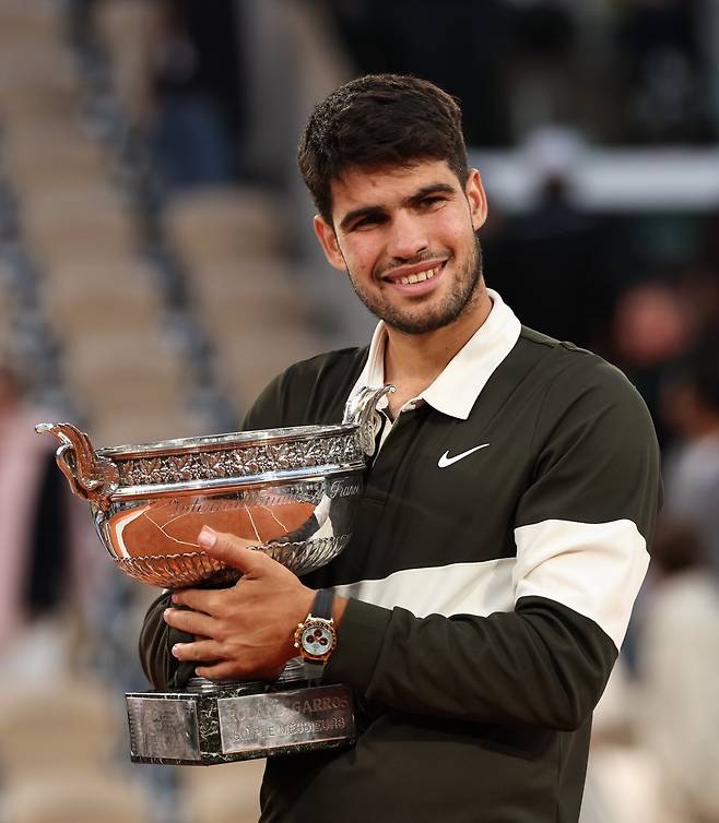 카를로스 알카라스가 9일(한국시간) 프랑스 파리의 롤랑가로스에서 열린 ‘2025 프랑스오픈’ 남자 단식 결승전에서 야닉 시너에게 3-2로 역전승한 뒤 우승 트로프를 껴안고 있다. 파리｜신화뉴시스