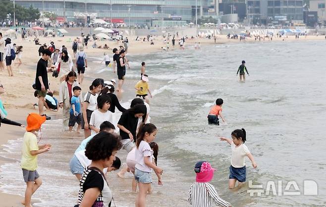 [부산=뉴시스] 하경민 기자 = 전국에 무더운 날씨가 이어진 지난 8일 부산 해운대구 해운대해수욕장을 찾은 시민과 관광객들이 물놀이를 즐기고 있다. 2025.06.08. yulnetphoto@newsis.com