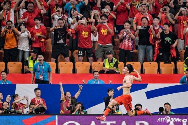 왕위동(아래)이 10일(한국시간) 중국 충칭의 롱싱 축구 경기장에서 열린 2026 국제축구연맹(FIFA) 북중미월드컵 3차 예선 최종전 바리엔과 경기 후반 추가시간 페널티킥 결승골을 넣고 상의 탈의 세리머니를 하고 있다. /AFPBBNews=뉴스1