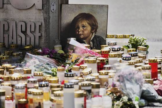 지난 12일(현지시간) 오스트리아 그라츠의 총기 난사 사건이 벌어진 한 고등학교 입구에 촛불과 꽃, 사진 등이 놓여 있다. AP=연합뉴스