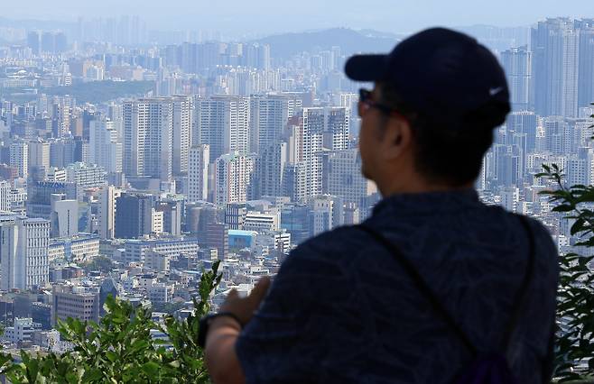 지난 12일 서울 남산을 찾은 시민이 도심 아파트단지 등을 바라보고 있다. 뉴스1