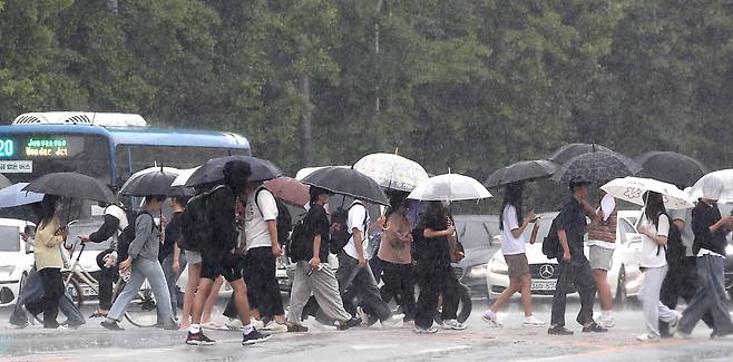 많은 비가 내린 13일 오후 대구 달서구 계명대 성서캠퍼스 앞 도로에서 우산을 쓴 시민들이 발걸음을 재촉하고 있다./뉴스1