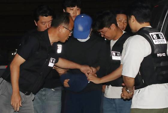 The suspect who murdered a woman he had been stalking in Daegu is escorted to Seongseo Police Precinct in Daegu on June 15. [NEWS1]