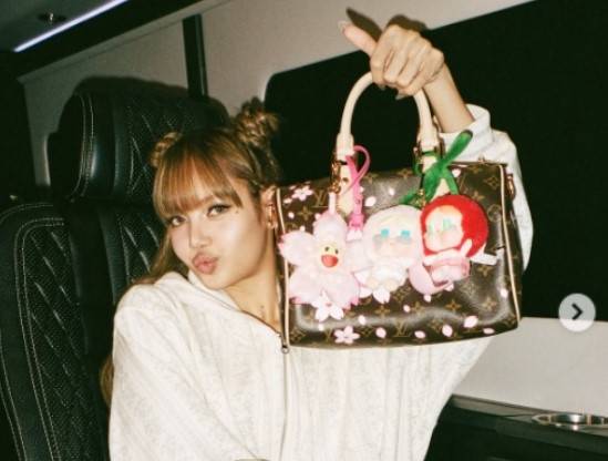 블랭핑크 리사가 ‘라부부’ 인형이 달린 핸드백을 들어 보이고 있다. [블랙핑크 리사 인스타그램]