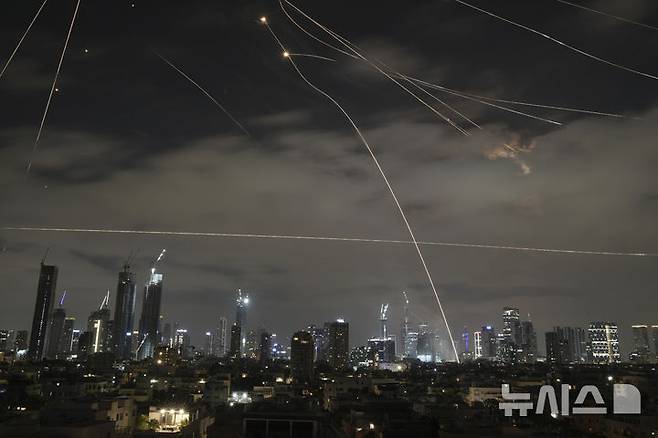 [텔아비브=AP/뉴시스] 15일(현지 시간) 이스라엘 텔아비브 상공에서 이스라엘 방공 시스템 아이언 돔이 이란 미사일을 제거하기 위해 요격 미사일을 발사하고 있다. 2025.06.16.