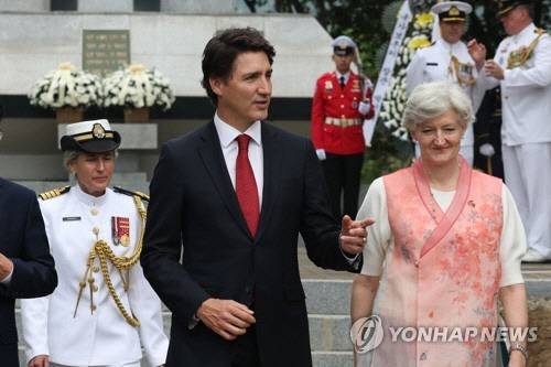 쥐스탱 트뤼도 캐나다 총리(가운데)가 지난 2023년 5월 18일 경기도 가평군 북면 이곡리 캐나다전투기념비에서 헌화를 마친 뒤 '한국전에 있어서의 캐나다의 기여' 비석을 가리키고 있다. 오른쪽은 개량 한복을 입은 타마라 모휘니 주한 캐나다 대사. [가평=연합뉴스]
