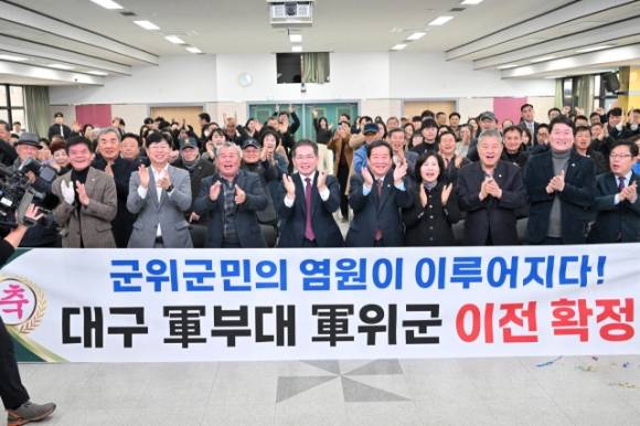 지난 3월 5일 대구시가 도심 군부대 이전지로 군위군을 발표하자 김진열(왼쪽에서 네번째) 대구 군위군수와 최규종 군의회 의장, 군의원 ,  주민 등이 일제히 박수갈채를 쏟아내며 환호성을 지고 있다. 군위군 제공