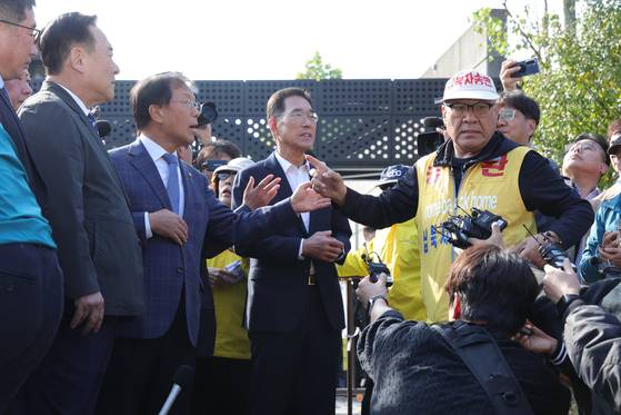 Choi Seong-ryong, right, head of the Families of Abductees to North Korea, argues with Democratic Party Rep. Youn Hu-duk, who is attempting to dissuade the activist group from launching leaflets in Paju, Gyeonggi, on Oct. 31, 2024. [YONHAP]
