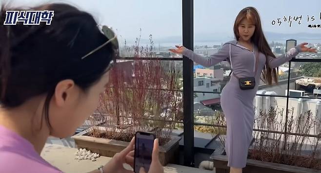 A screenshot from a video by Psick University, a popular YouTube comedy channel, featuring a comedian dressed in a long fitted dress to model the "Dongtan look." (YouTube)