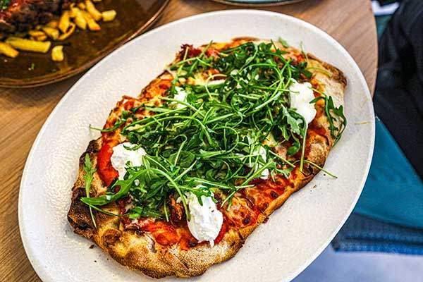 Pinsa serrano, rucola and burrata.