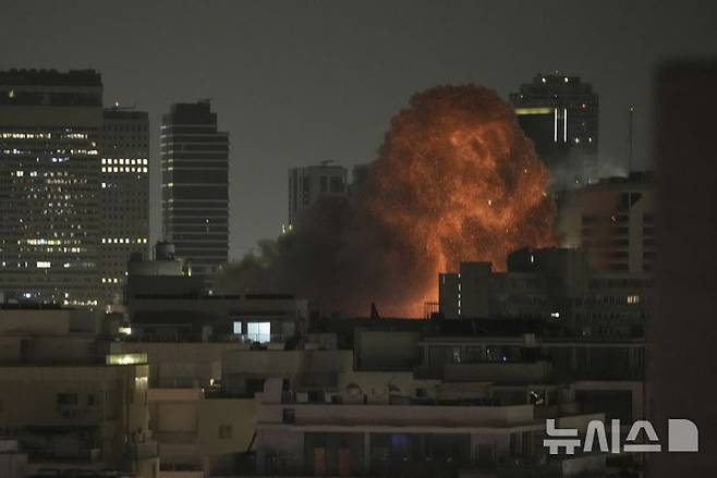 [텔아비브=AP/뉴시스] 15일(현지 시간) 이란의 미사일 공격을 받은 이스라엘 텔아비브에서 폭발이 일어나고 있다. 2025.06.16.